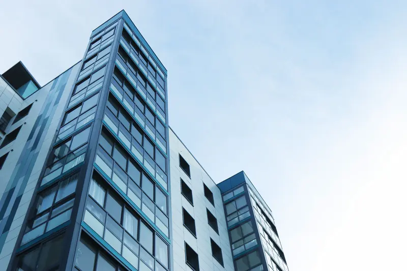 Sculptural modern architecture reaching into a clear sky