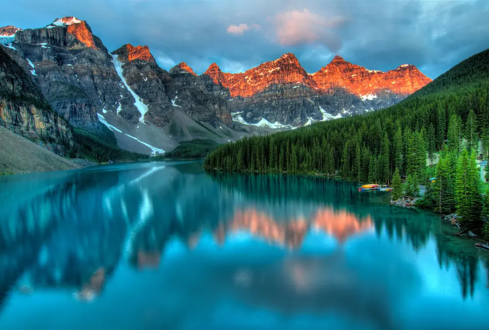 A tranquil mountain lake beneath a wide open sky